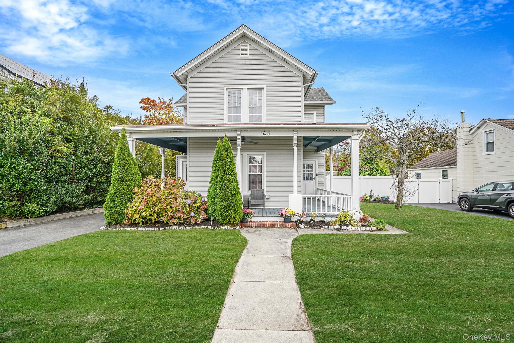 45 Maple Avenue Patchogue, NY 11772 - Photo 2 of 30 a front view of a house with a yard and porch