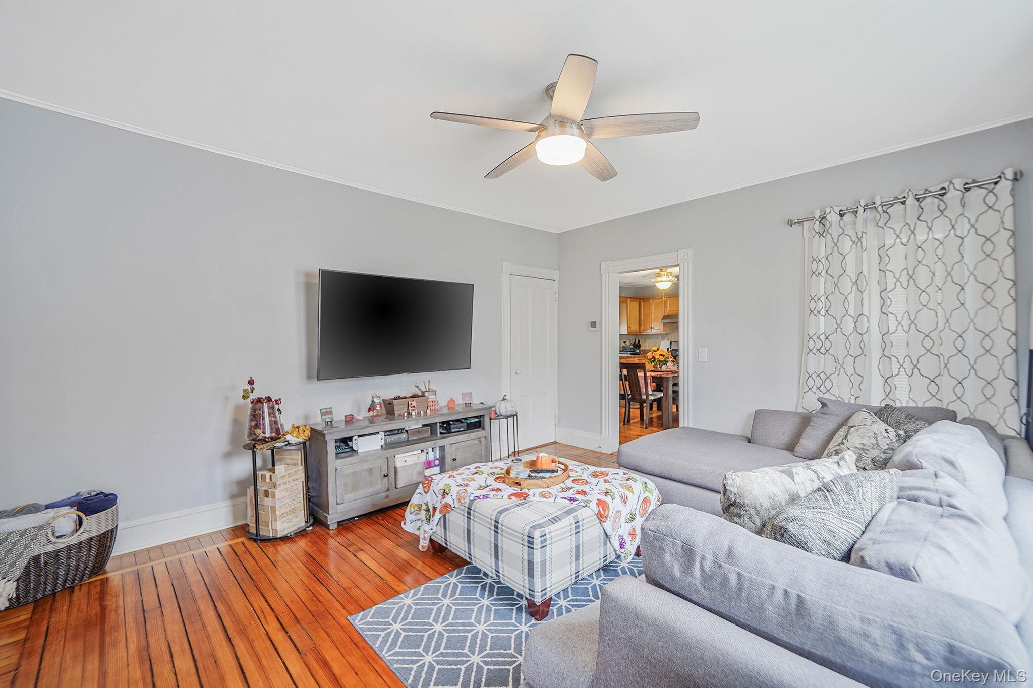 45 Maple Avenue Patchogue, NY 11772 - Photo 4 of 30 a living room with furniture and a flat screen tv