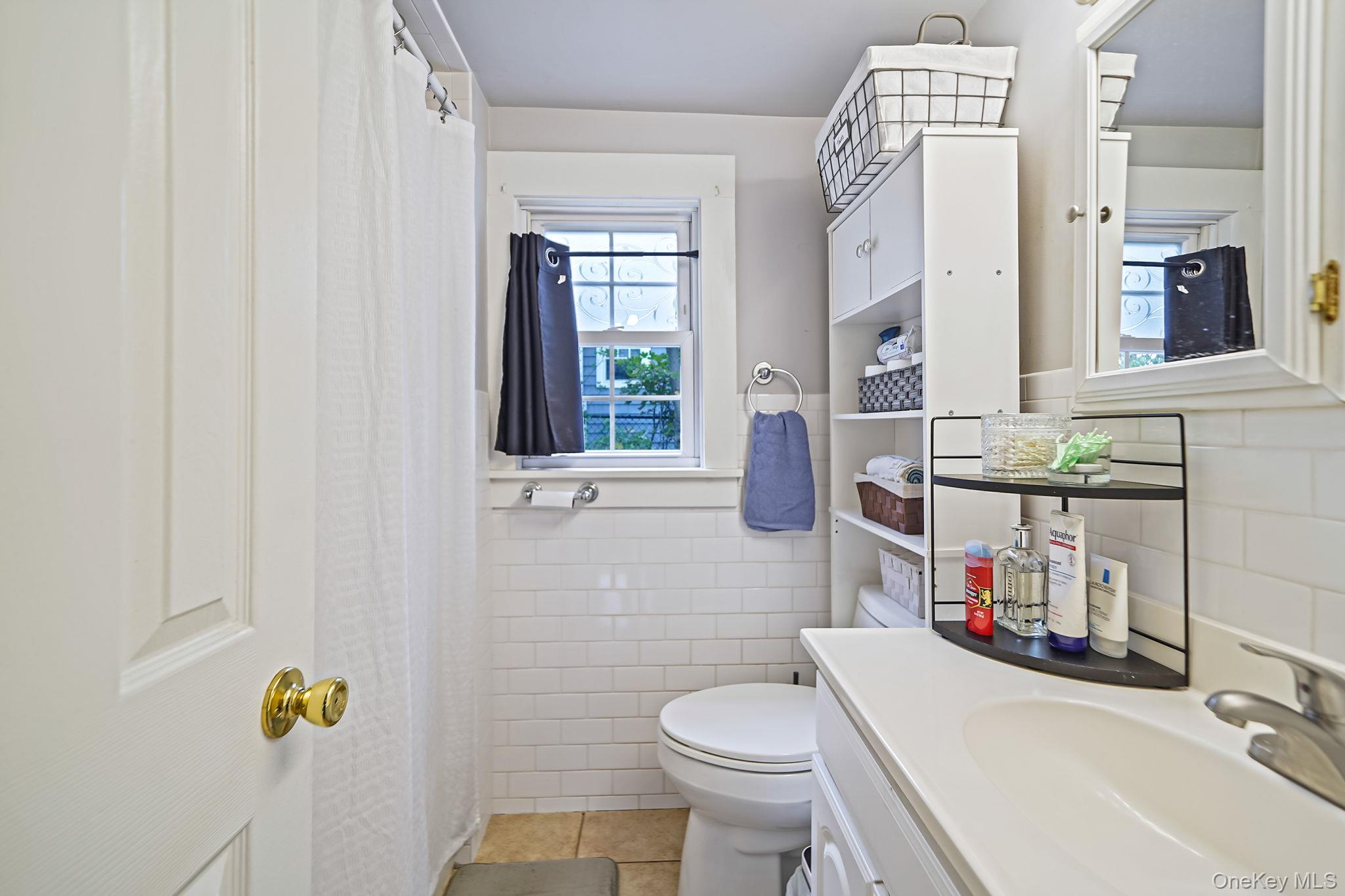 45 Maple Avenue Patchogue, NY 11772 - Photo 8 of 30 a bathroom with a sink toilet and shower