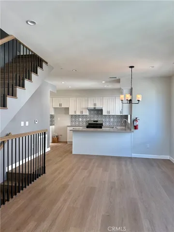 a view of kitchen with kitchen island microwave and cabinets