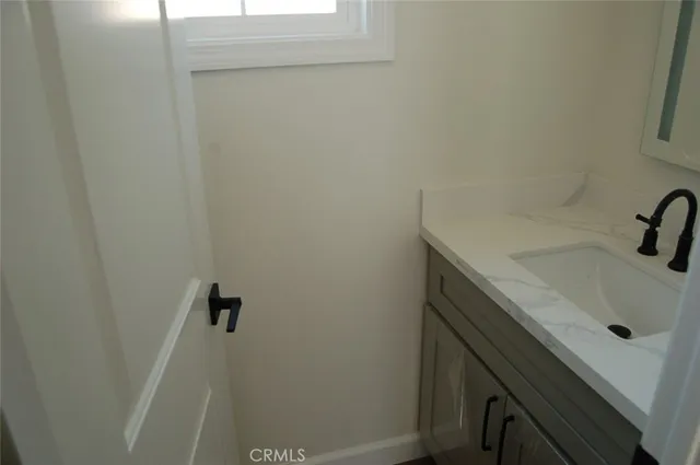 a bathroom with a sink and cabinets