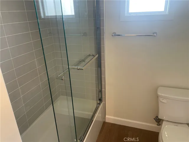 a bathroom with a shower and toilet