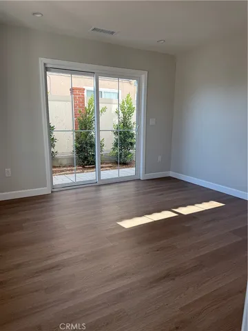 a view of room with window and wooden floor