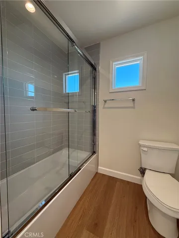 a bathroom with a toilet and a shower