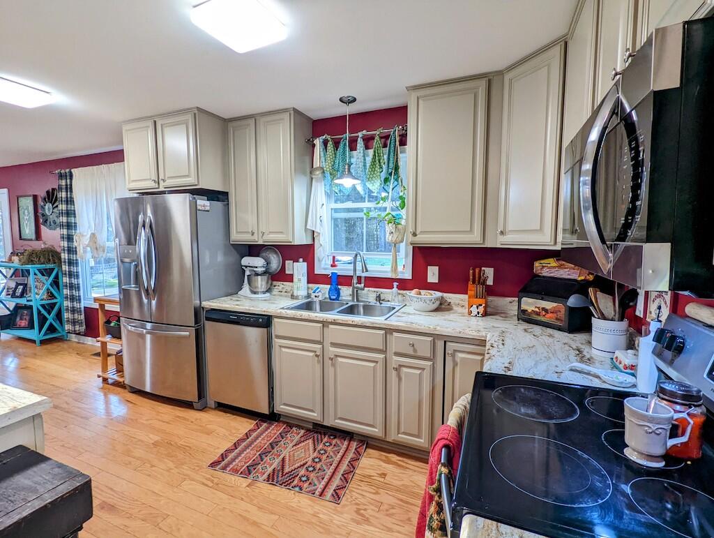 2055 Sunny Ridge Road Northeast Check, VA 24072 - Photo 11 of 35 a kitchen with stainless steel appliances granite countertop a sink refrigerator stove and microwave