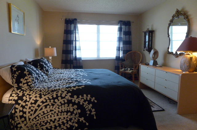 2079 Exeter Boca Raton, FL 33434 - Photo 8 of 17 a bedroom with a bed and a mirror