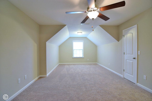 2510 Ridgewood Way Phenix City, undefined 36870 - Photo 18 of 20 an empty room with a chandelier fan and windows
