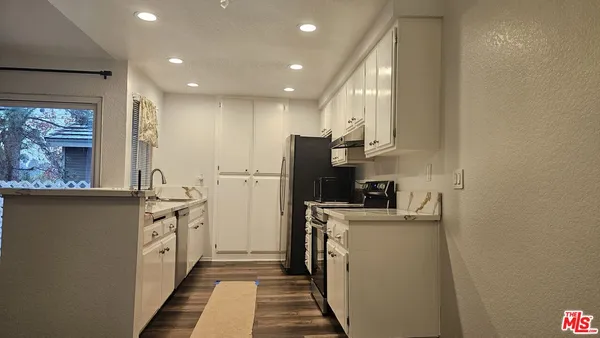 a kitchen with cabinets and stainless steel appliances