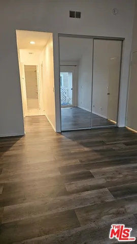 a view of hallway with wooden floor