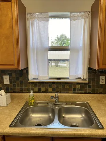 a bathroom with a granite countertop sink and a bathtub