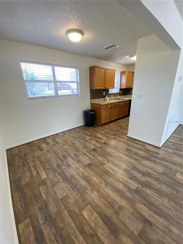 a view of kitchen and wooden floor