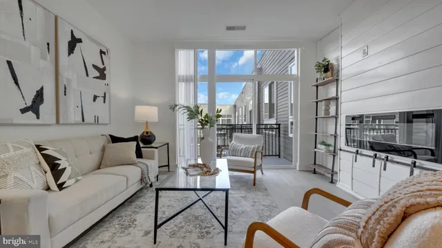 a living room with furniture and large window