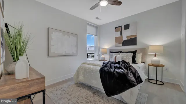 a bed room with a bed and a potted plant