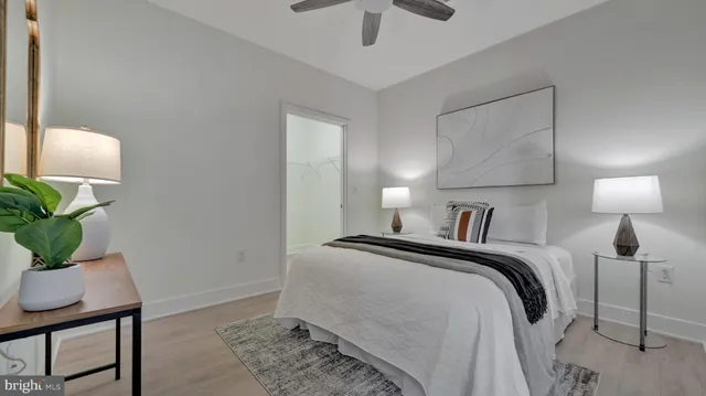 a bedroom with a bed and a lamp on table