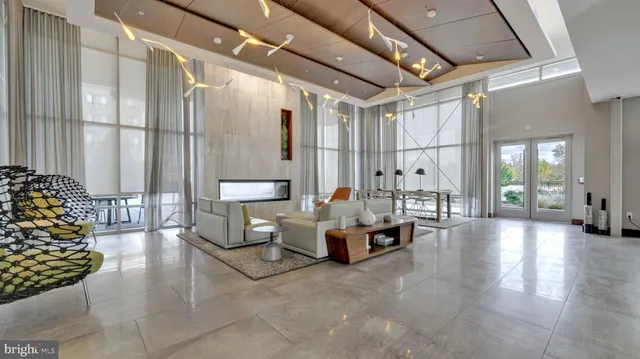 a living room with furniture and large windows