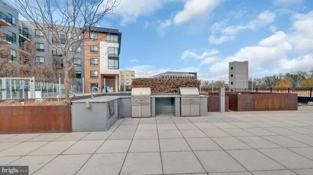 a room with lots of gym equipment and a view of living room