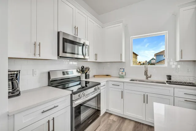a dining room with furniture a chandelier and wooden floor