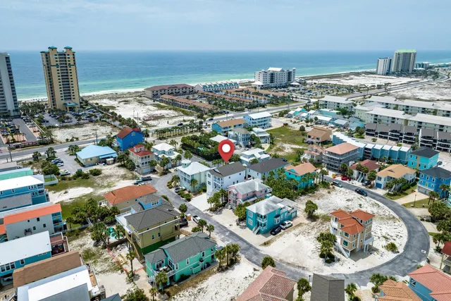 an aerial view of a house with outdoor space lake view and ocean view