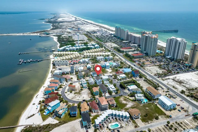 an aerial view of a house with a yard and outdoor seating