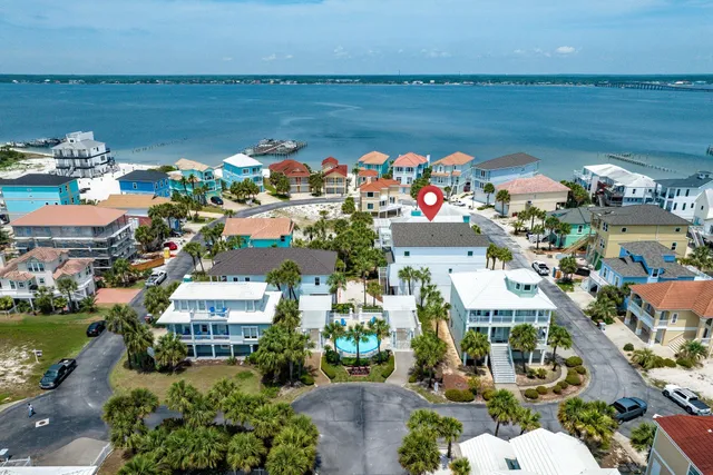 a large white kitchen with lots of counter space a dining table and chairs