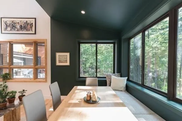 a living room with furniture and large windows