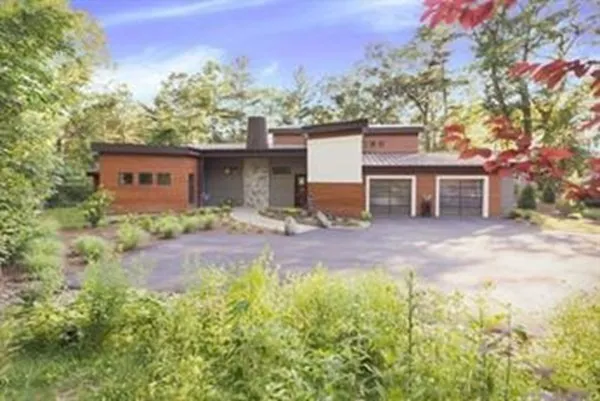 a view of a house with backyard and sitting area
