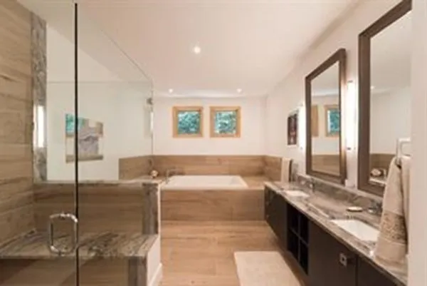 a large bathroom with a large tub and sink