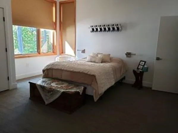 a bedroom with bed and a window