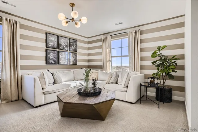 a living room with furniture and a potted plant