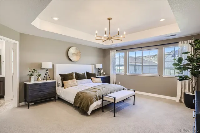 a bedroom with a bed and a chandelier