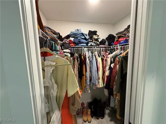 a bedroom with a bed and a chair