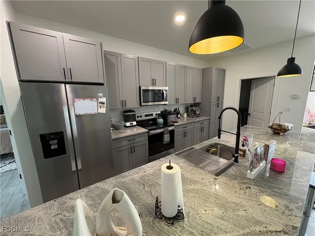 a work room with furniture and a floor to ceiling window