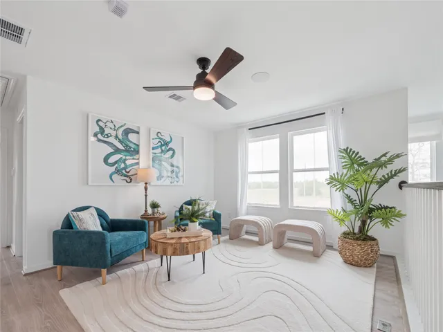 a living room with furniture and a potted plant