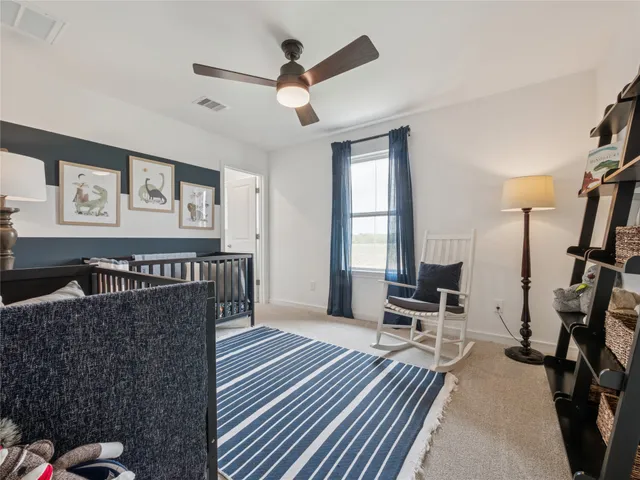 a view of a livingroom with wooden floor and a flat screen tv