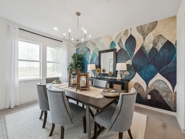 a view of a dining room with furniture and chandelier