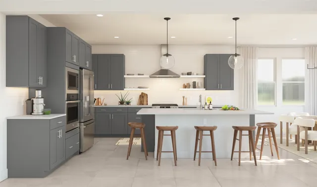 a kitchen with stainless steel appliances granite countertop a sink a stove a refrigerator and chairs