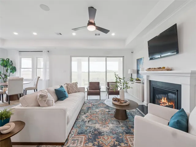 a living room with furniture a flat screen tv and a fireplace
