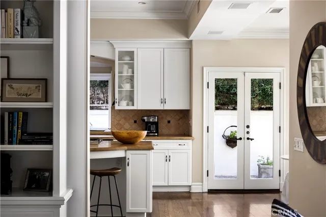 a kitchen with a sink cabinets and wooden floor