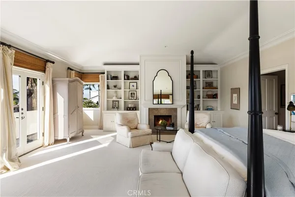 a bedroom with furniture and a large window