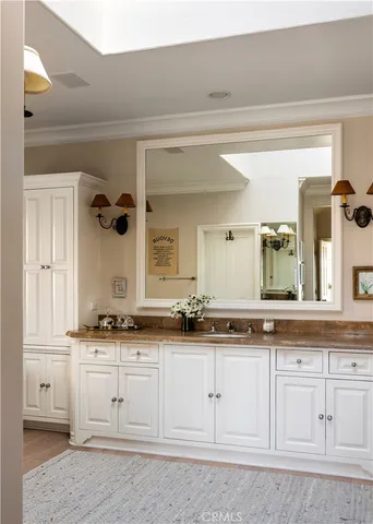 a bathroom with double vanity windows and a bathtub