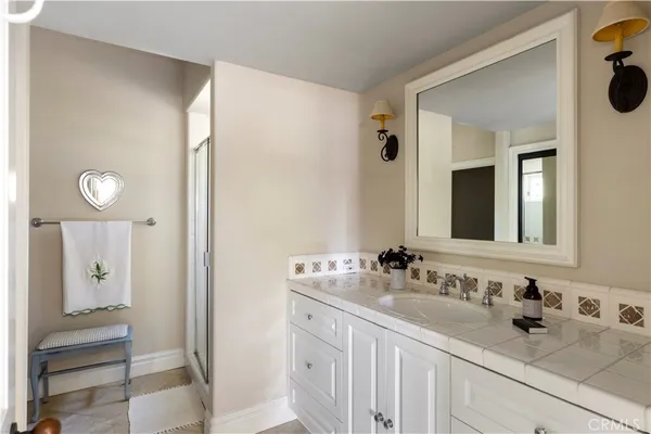 a view of a hallway with closet and bathroom