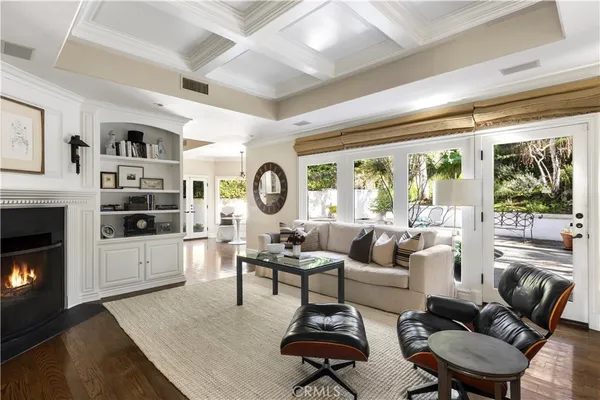 a living room with furniture and large windows