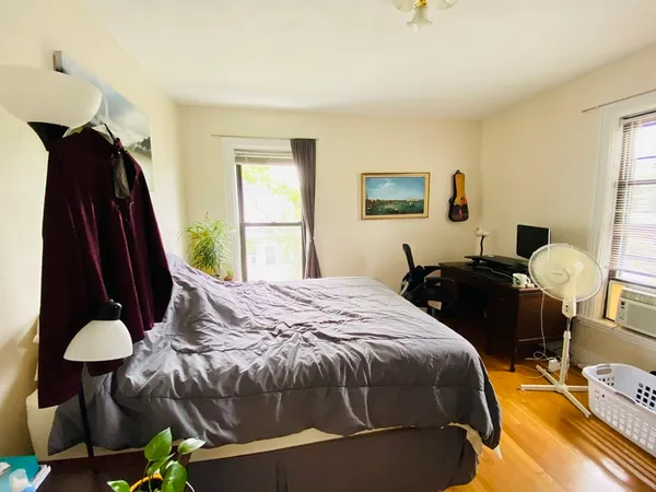a bed room with a bed and a window