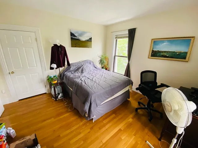 a bedroom with a bed and a mirror