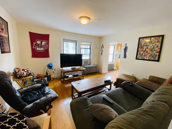 a living room with furniture a rug and a window