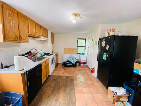 a kitchen with a sink appliances and cabinets