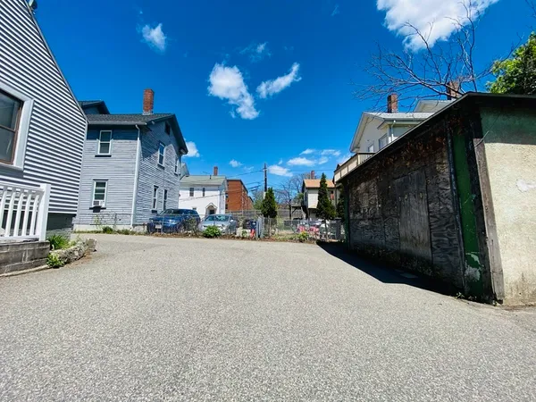 a view of a street with potted plants