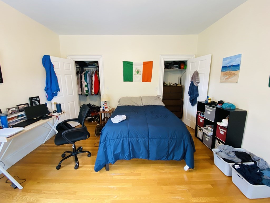 48 Allston Street, Unit 2 Boston, MA 02134 - Photo 4 of 24 a bedroom with furniture and a gym equipment