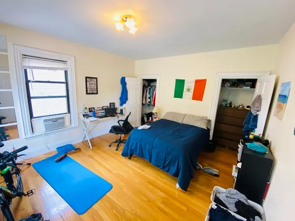 a bedroom with furniture and a window