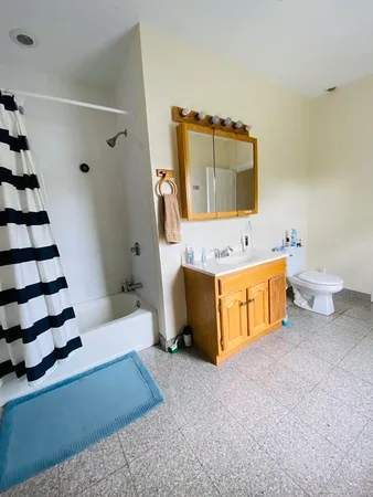 a spacious bathroom with a tub sink and toilet